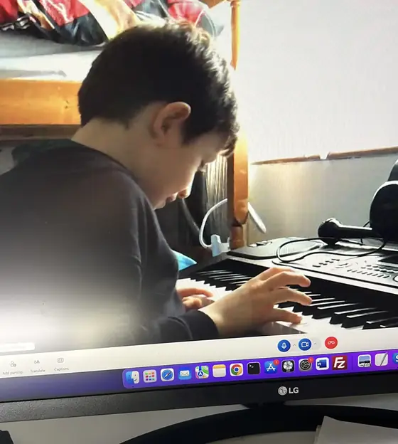 Student at the piano at Stars Music School, Inwood WV