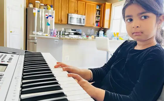Student at the piano at Stars Music School, Inwood WV